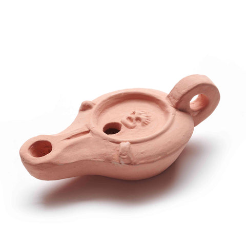 A terracotta replica of a Roman ceramic oil lamp, featuring a simple yet intricate design, with a visible handle and two holes for oil and wick.