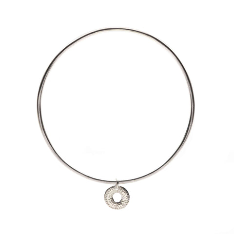 Silver bangle with a round pendant on a white background
