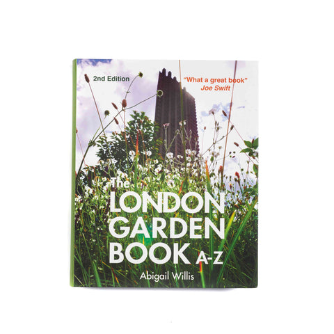 Front cover of a book titled London Garden Book A-Z featuring some grass and wildflowers in the foregrounds and a tall building in the background