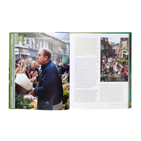 Open book showing images of a market scene with people and buildings.