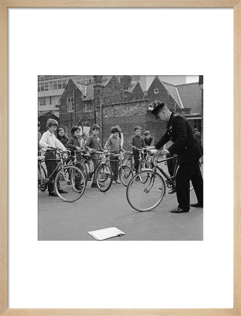 A policeman trains school children for their National Cycling Proficiency test at St. Mary's School, Finchley