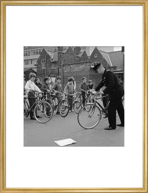 A policeman trains school children for their National Cycling Proficiency test at St. Mary's School, Finchley
