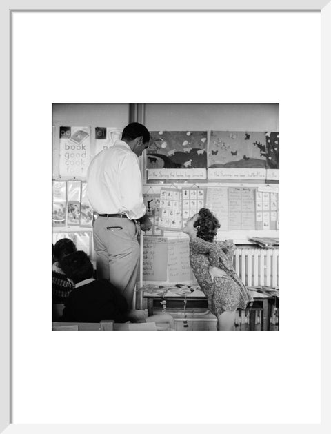 Girl sticking her tongue out at the teacher.