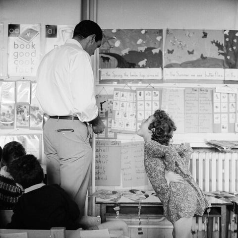 Girl sticking her tongue out at the teacher.
