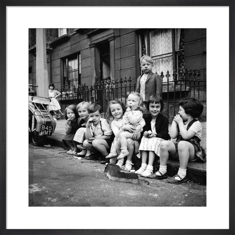 Children sitting on the curb Maida Vale 1960