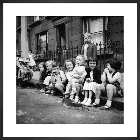 Children sitting on the curb Maida Vale 1960