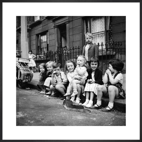Children sitting on the curb Maida Vale 1960