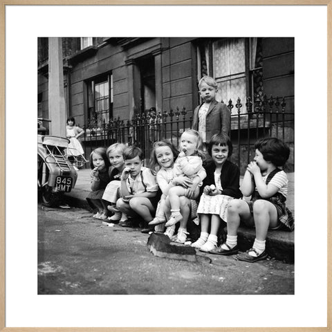 Children sitting on the curb Maida Vale 1960