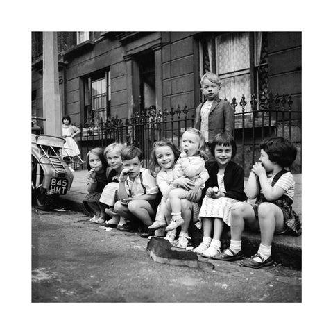 Children sitting on the curb Maida Vale 1960