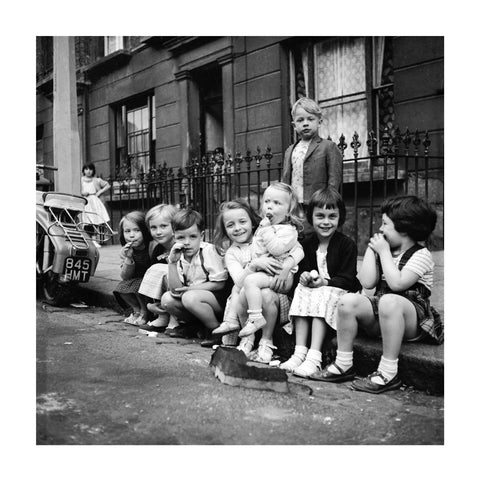 Children sitting on the curb Maida Vale 1960