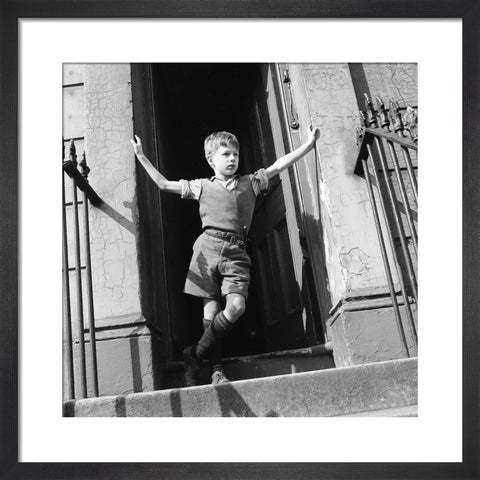 Boy standing in open doorway 1957