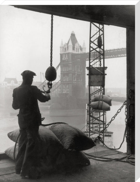 Pool of London Dockworker handling a cargo of bagged nuts 1947