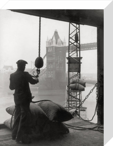 Pool of London Dockworker handling a cargo of bagged nuts 1947