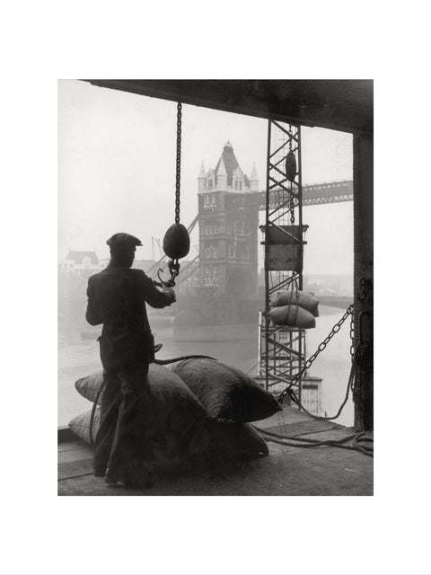 Pool of London Dockworker handling a cargo of bagged nuts 1947