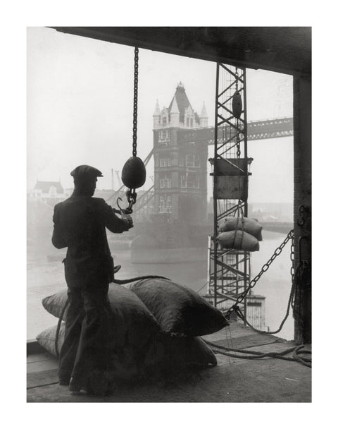 Pool of London Dockworker handling a cargo of bagged nuts 1947