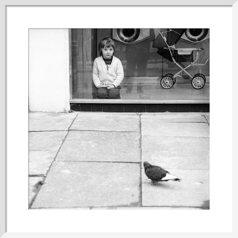 Boy watching a pigeon in Boreham Wood c.1965