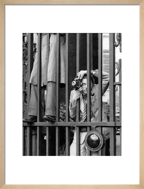 A photographer takes a picture through the railings at Admiralty Arch 1953