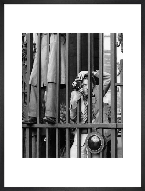 A photographer takes a picture through the railings at Admiralty Arch 1953