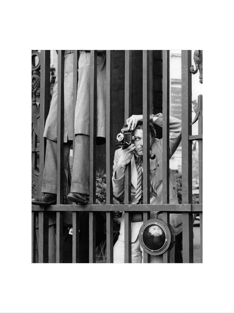 A photographer takes a picture through the railings at Admiralty Arch 1953