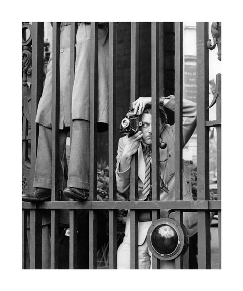 A photographer takes a picture through the railings at Admiralty Arch 1953