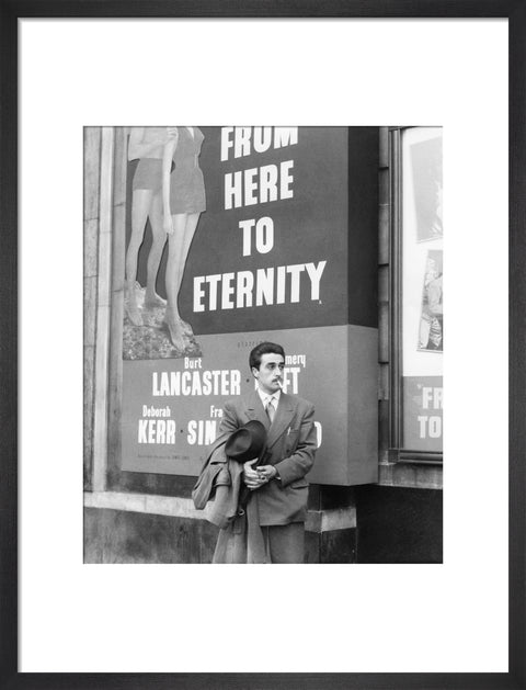A man standing outside the Odeon cinema at Hyde Park Corner c. 1953