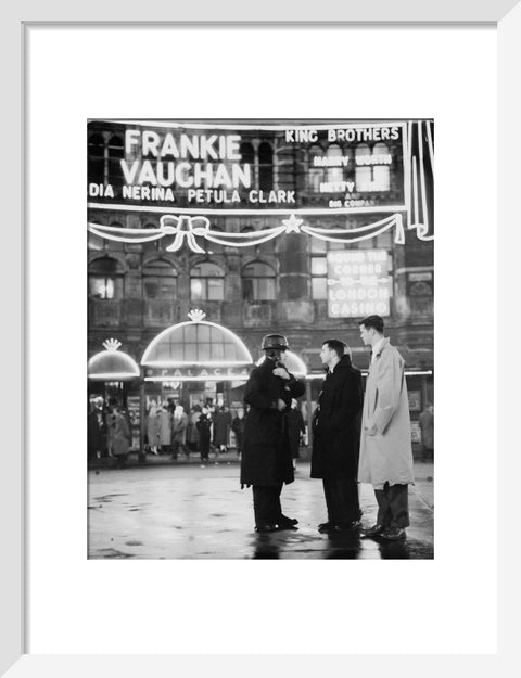 A group of men talking outside the Palace Theatre Shaftsbury Avenue c. 1955
