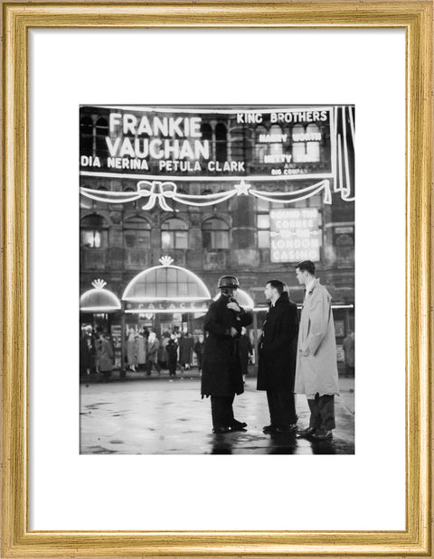 A group of men talking outside the Palace Theatre Shaftsbury Avenue c. 1955