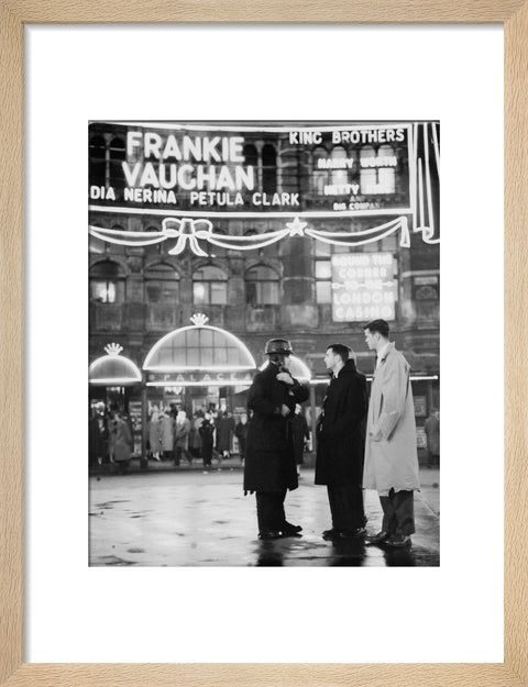 A group of men talking outside the Palace Theatre Shaftsbury Avenue c. 1955