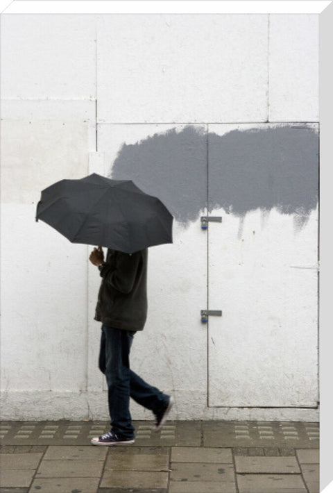 A man walking with umbrella in New Oxford Street 2008