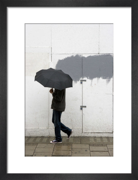A man walking with umbrella in New Oxford Street 2008