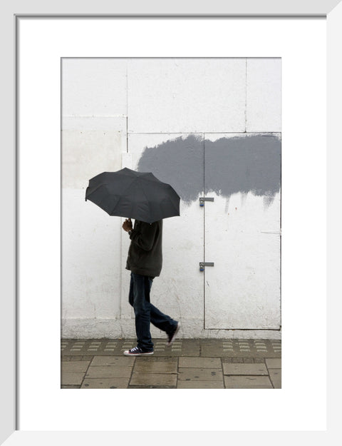 A man walking with umbrella in New Oxford Street 2008