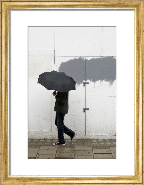A man walking with umbrella in New Oxford Street 2008