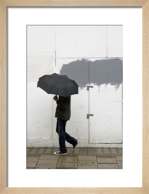 A man walking with umbrella in New Oxford Street 2008