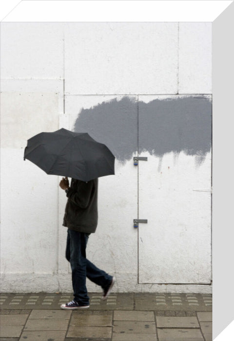 A man walking with umbrella in New Oxford Street 2008