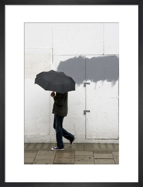 A man walking with umbrella in New Oxford Street 2008