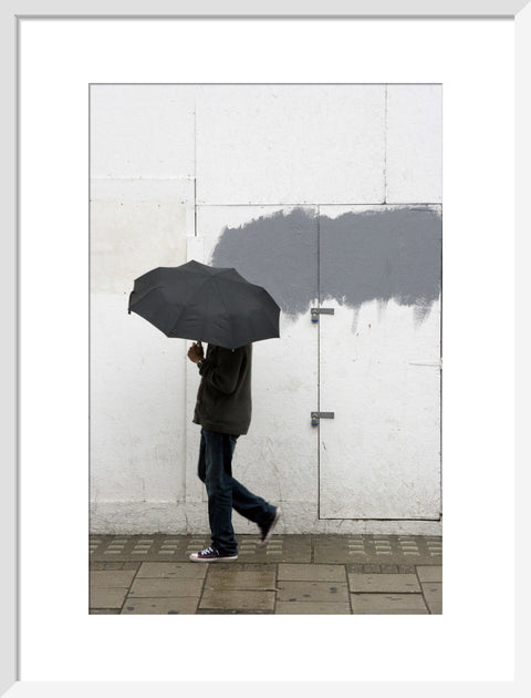A man walking with umbrella in New Oxford Street 2008
