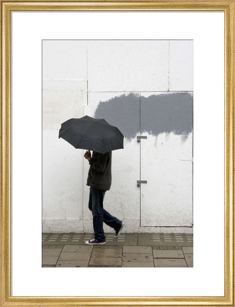 A man walking with umbrella in New Oxford Street 2008