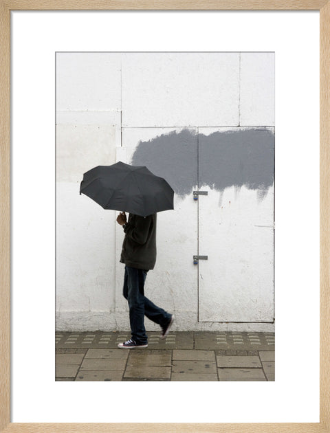 A man walking with umbrella in New Oxford Street 2008