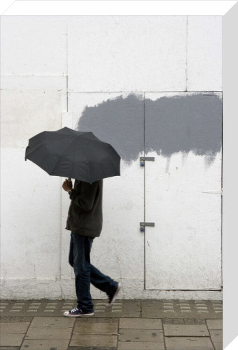 A man walking with umbrella in New Oxford Street 2008