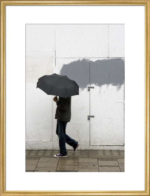 A man walking with umbrella in New Oxford Street 2008