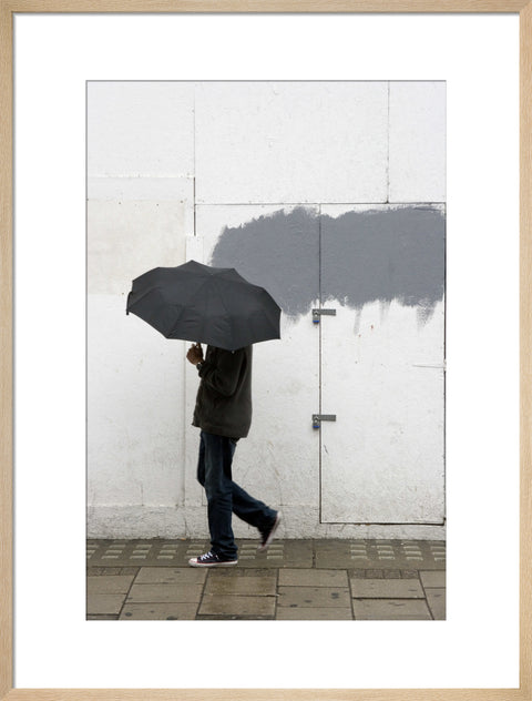 A man walking with umbrella in New Oxford Street 2008