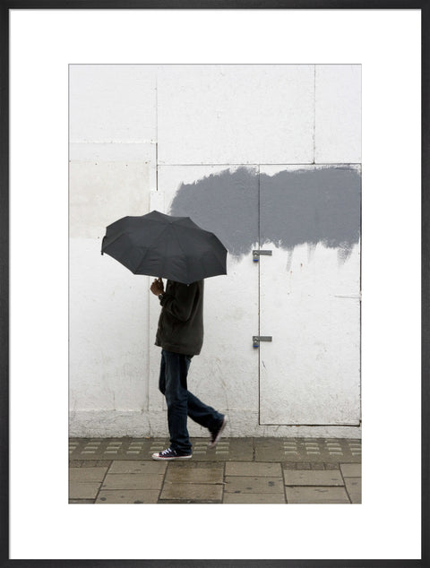 A man walking with umbrella in New Oxford Street 2008