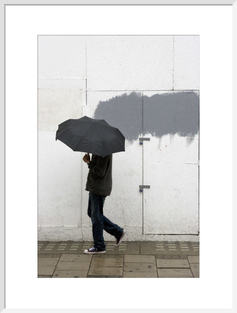 A man walking with umbrella in New Oxford Street 2008
