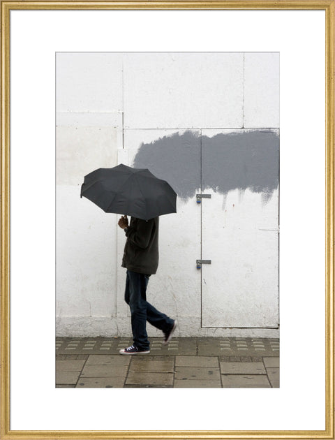 A man walking with umbrella in New Oxford Street 2008