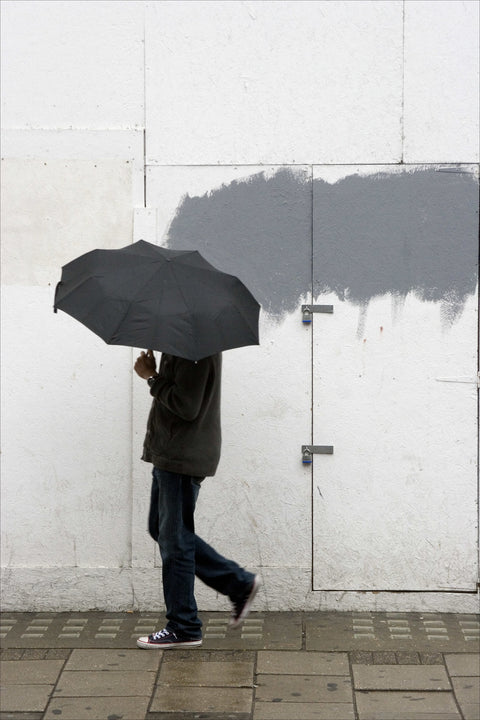 A man walking with umbrella in New Oxford Street 2008