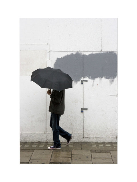 A man walking with umbrella in New Oxford Street 2008