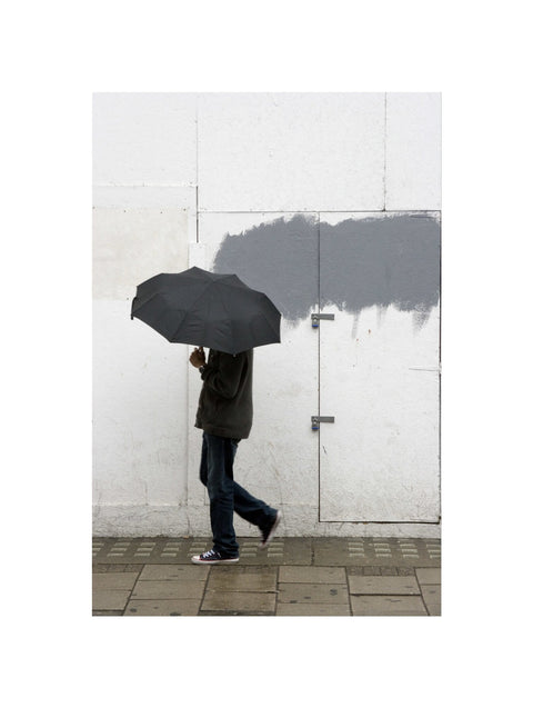 A man walking with umbrella in New Oxford Street 2008
