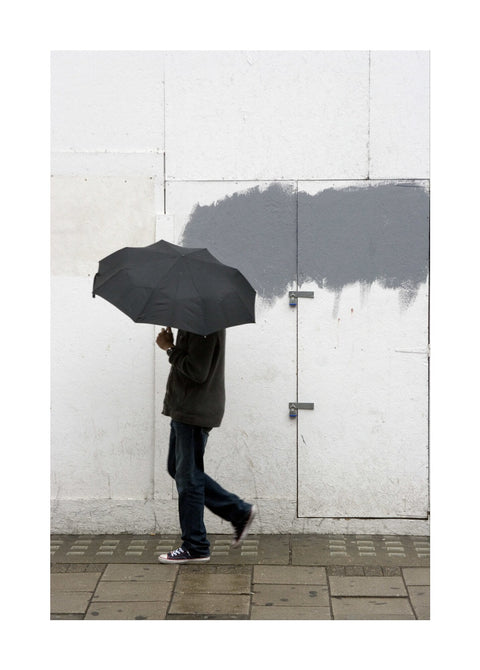 A man walking with umbrella in New Oxford Street 2008