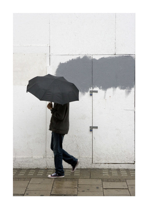 A man walking with umbrella in New Oxford Street 2008