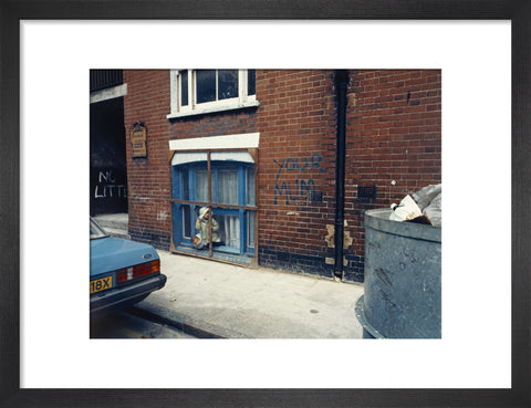 Two children looking out of a window 1986